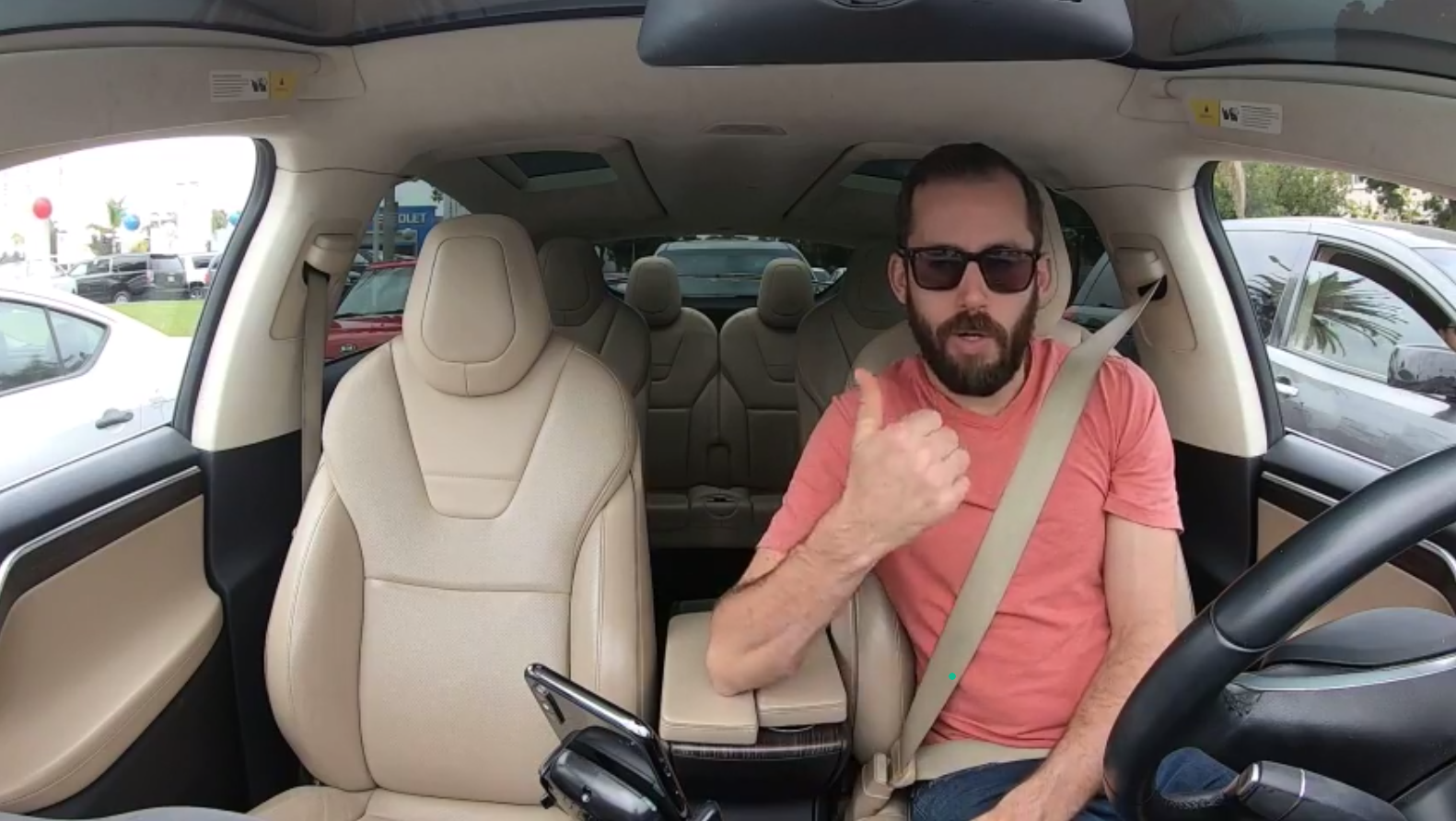 Brian sits in the driver's seat of John Zdanowski's Tesla Model X (Xandra) giving a thumbs up.